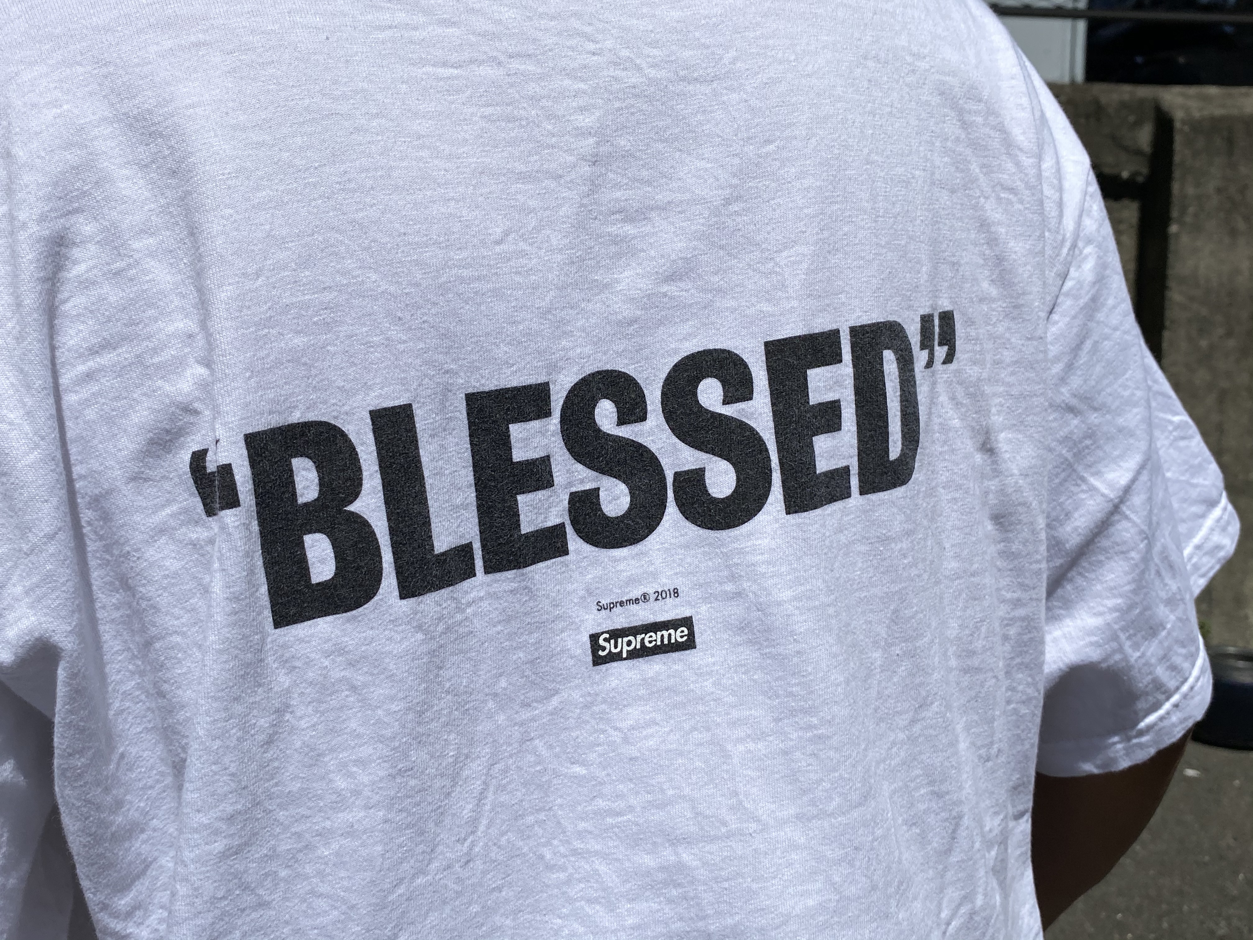white and blue supreme shirt