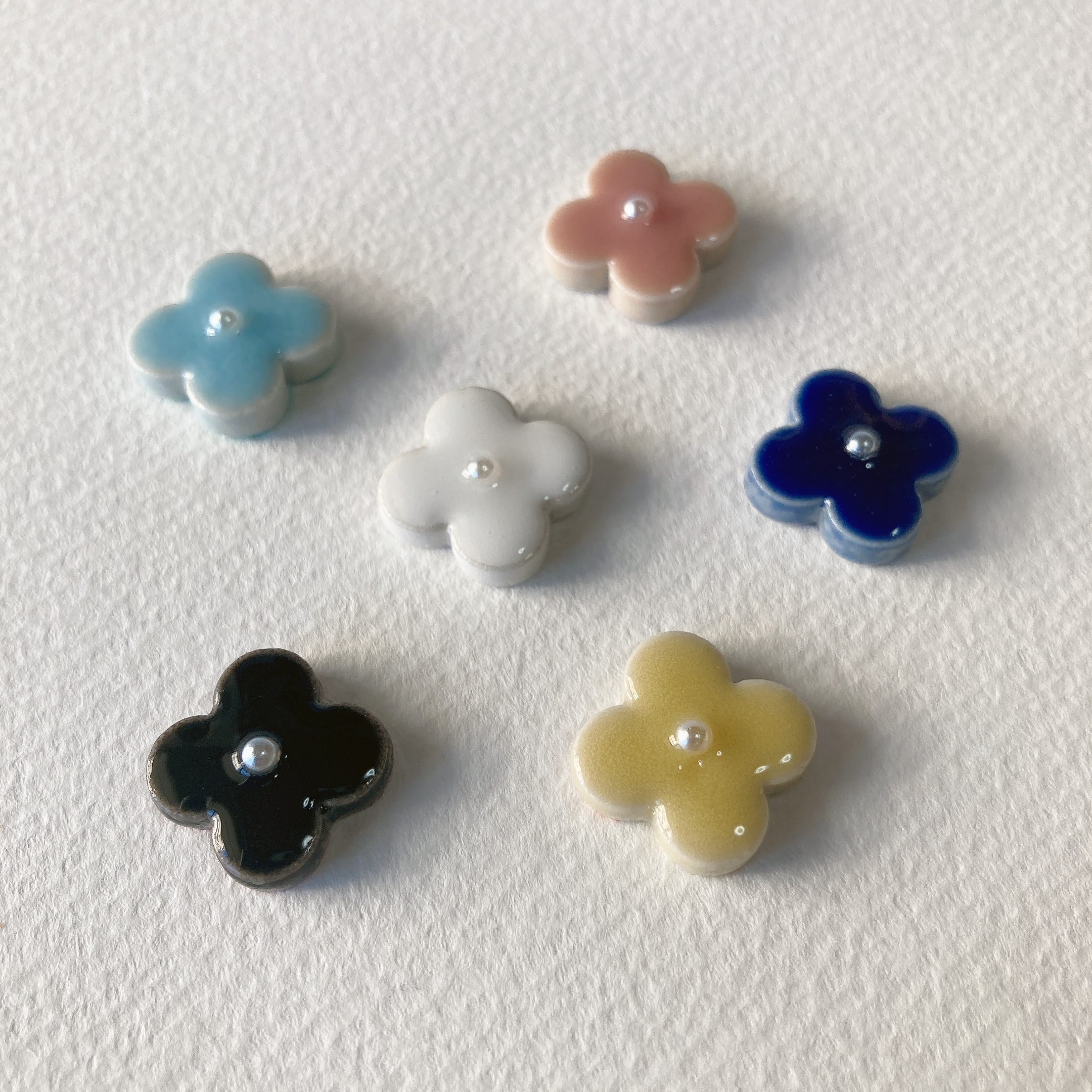 手元に色づくタイル素材の冬の花。
